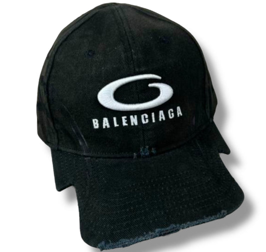 A black baseball cap with the 'Balenciaga' logo in white on the front.